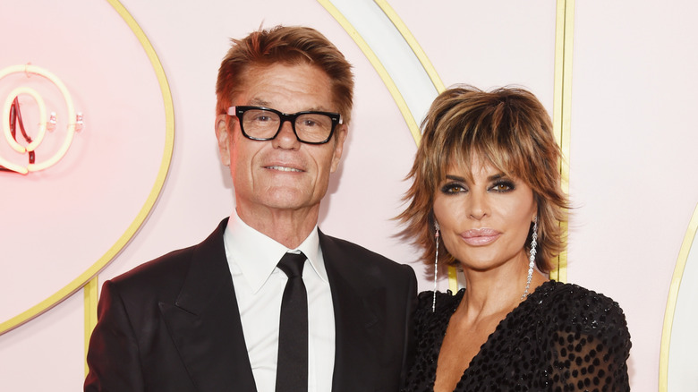 Harry Hamlin and Lisa Rinna, both wearing black, posing at a 2018 Emmys after party