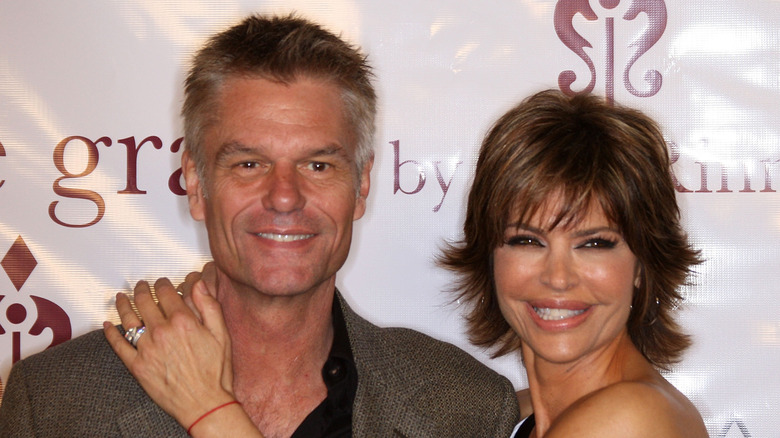 Harry Hamlin and Lisa Rinna, smiling with their arms around each other in 2010