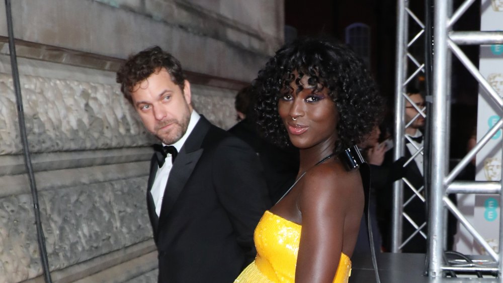 Joshua Jackson in a suit with Jodie Turner-Smith in a yellow dress