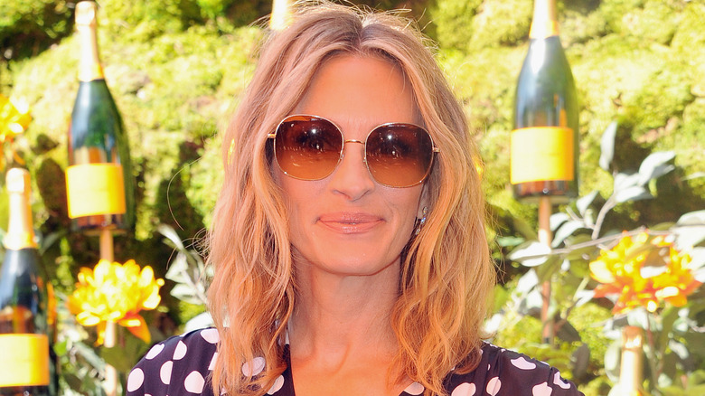 Julia Roberts wearing sunglasses and a polka dot dress
