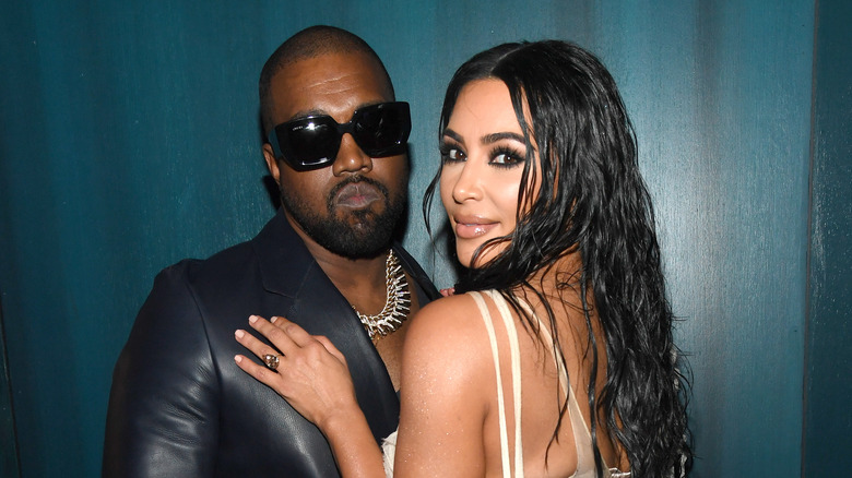 Kim Kardashian embracing Kanye West's chest