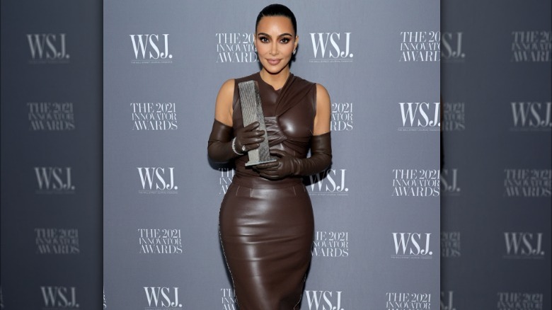Kim Kardashian holding Innovator Award 2021