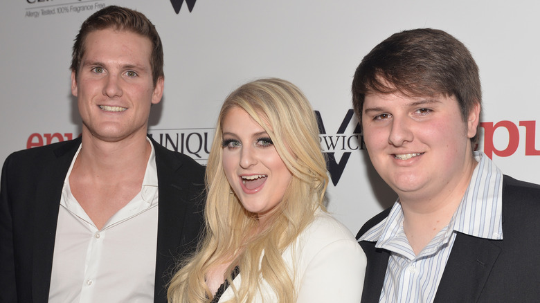 Meghan Trainor and brothers Ryan and Justin posing
