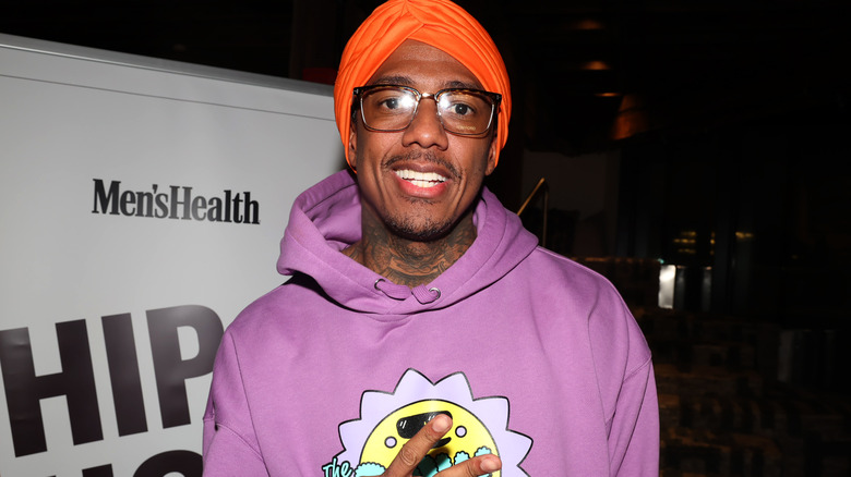 Nick Cannon posing at an event