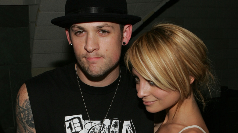 Joel Madden and Nicole Richie in casual clothes at a party in 2007