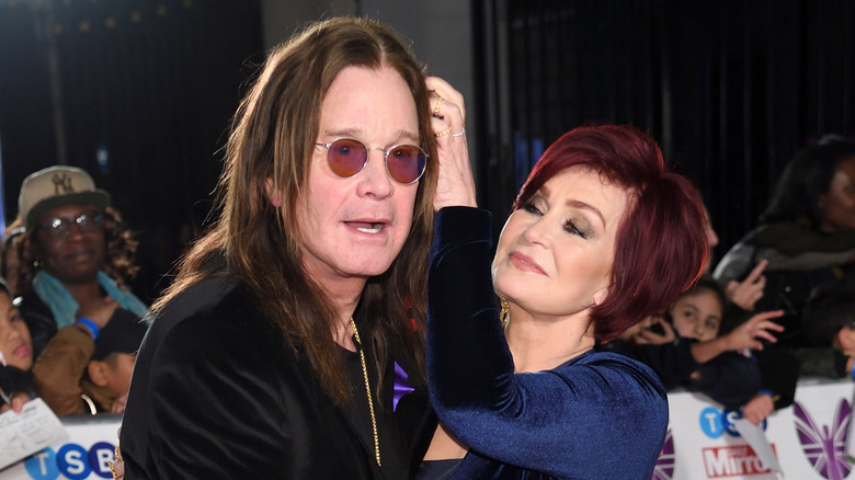 Sharon Osbourne fixing Ozzy Osbourne's hair