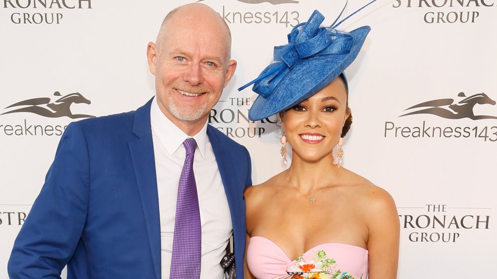 Michael Darby and Ashley Darby, smiling while posing arm in arm