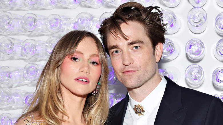 Robert Pattinson and Suki Waterhouse posing