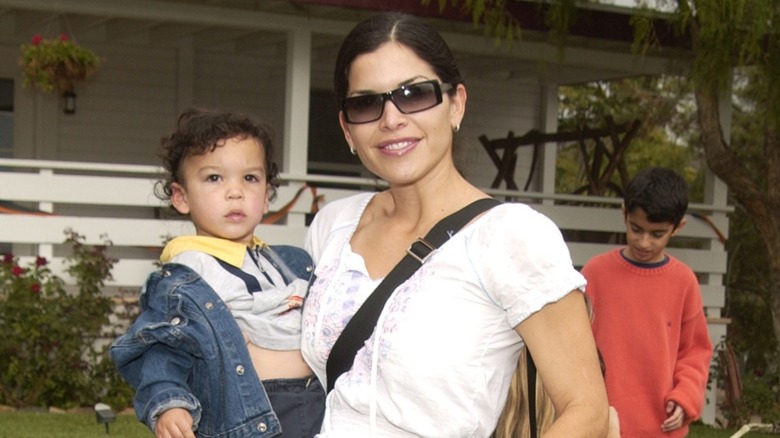 Lauren Sánchez smiling and holding young Nikko Sánchez in her arms.