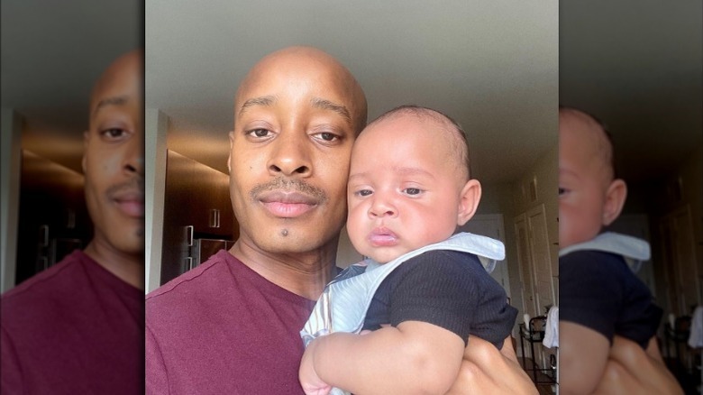 Adair Curtis holding his son Arrow