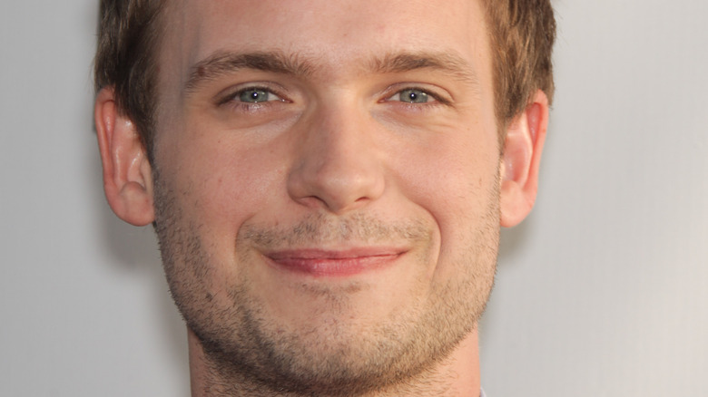 Patrick J. Adams smiles on the red carpet