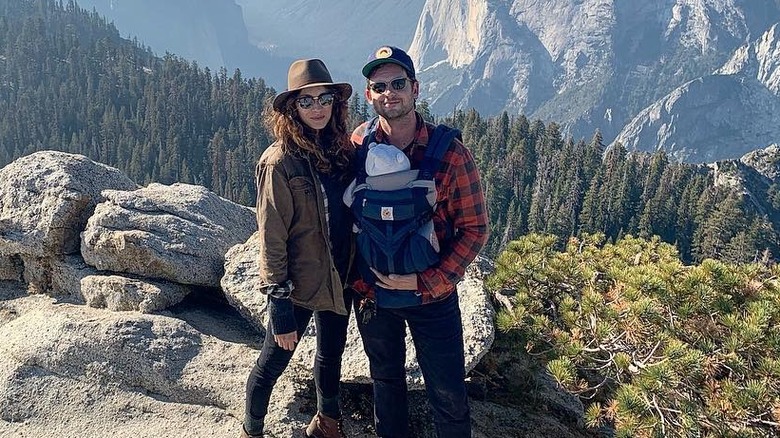Troian Bellisario and Patrick J. Adams with daughter Aurora on hike