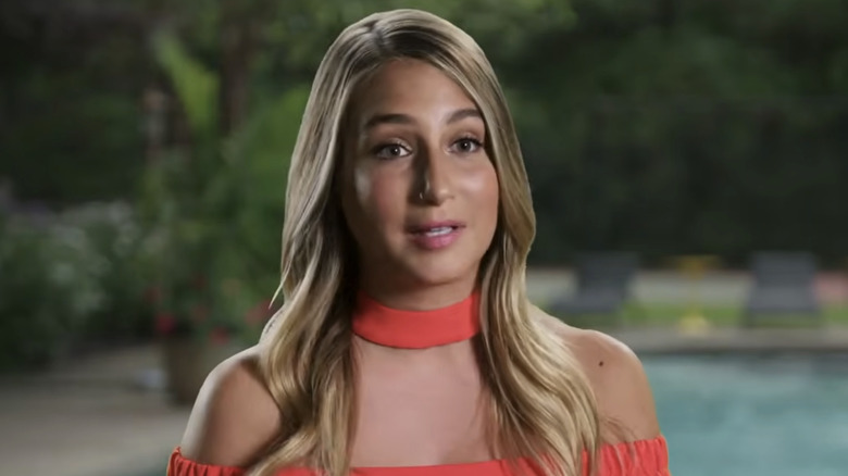 Amanda Batula wearing a red outfit with blonde hair