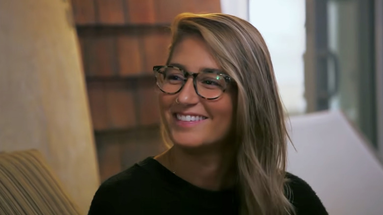 Amanda Batula wearing glasses with her hair let down