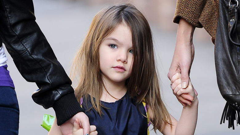 Suri Cruise holding hands