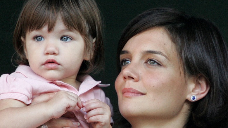 Katie Holmes holding up Suri Cruise