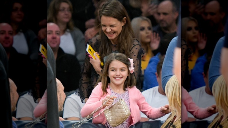 Katie Holmes laughing behind Suri Cruise
