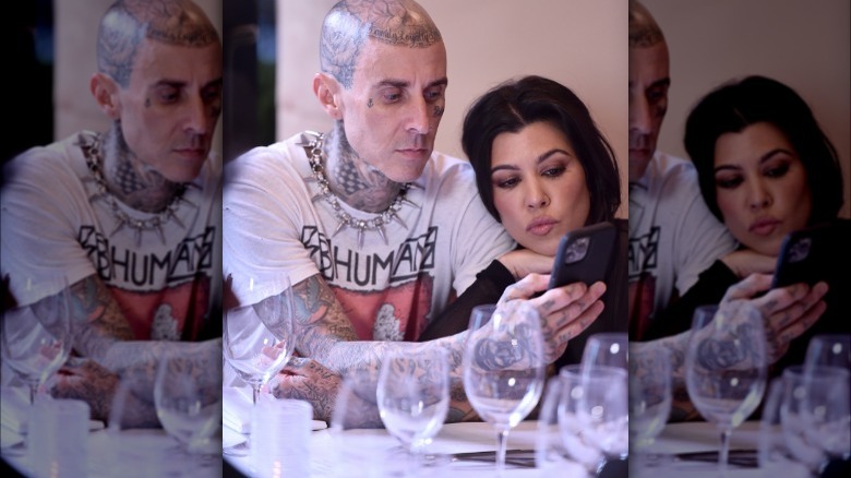 Kourtney Kardashian and Travis Barker taking a selfie