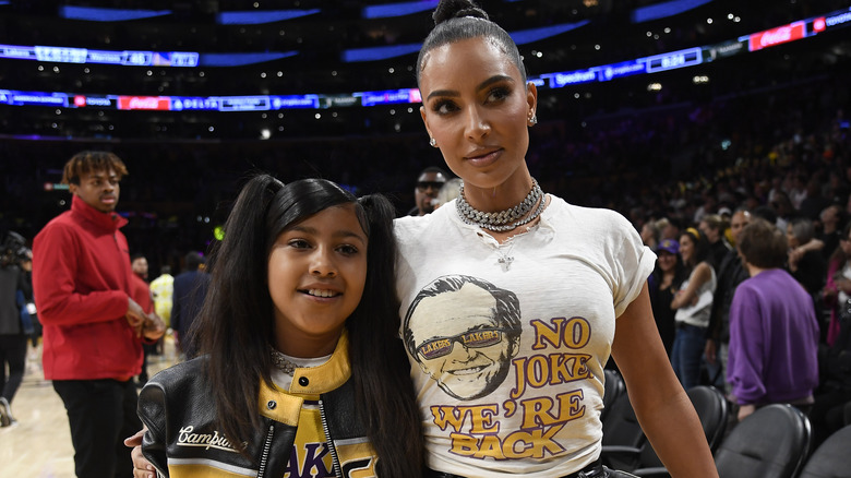 Kim Kardashian posing with North West 