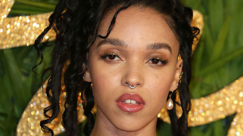 FKA twigs posing at an event