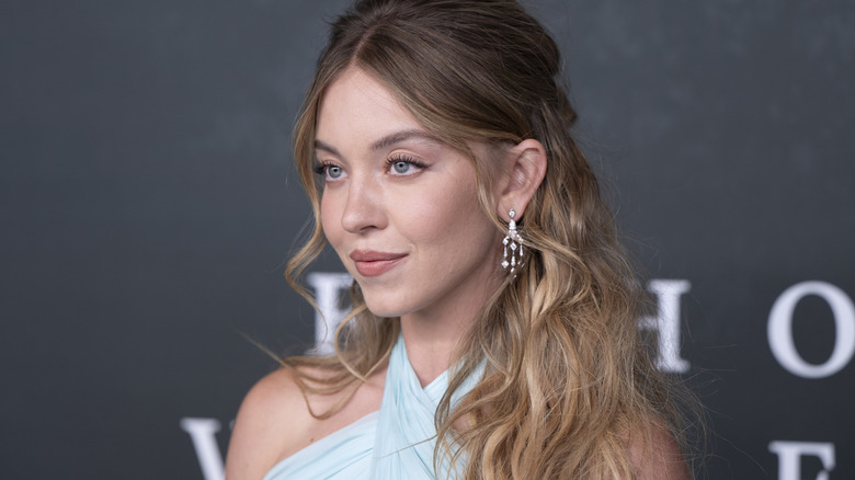 Sydney Sweeney posing in a baby blue outfit