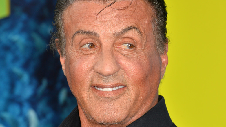 Sylvester Stallone smiling and looking to side