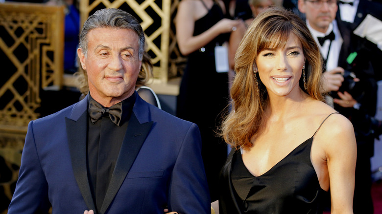 Sylvester Stallone, Jennifer Flavin posing