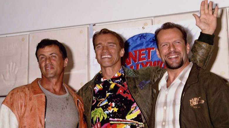 Sylvester Stallone, Arnold Schwarzenegger, and Bruce Willis waving