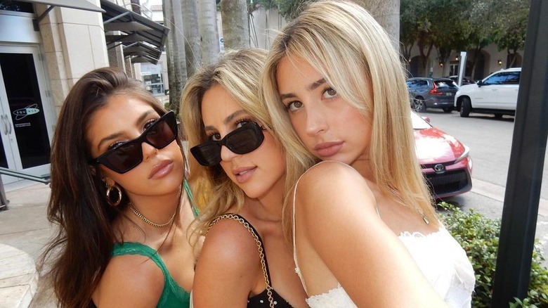 Scarlet Stallone posing with her sisters outdoors