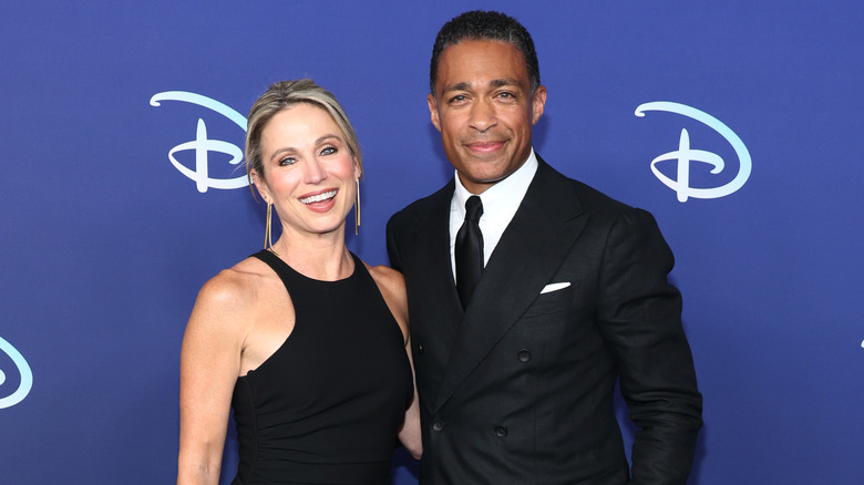 Amy Robach, TJ Holmes posing