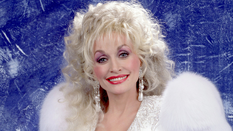 Dolly Parton sporting a white outfit for a studio portrait in 1989