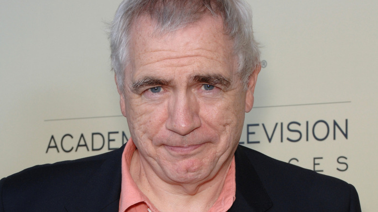 Brian Cox with his head tilted down