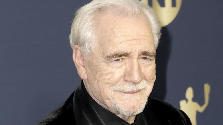 Brian Cox holding an award