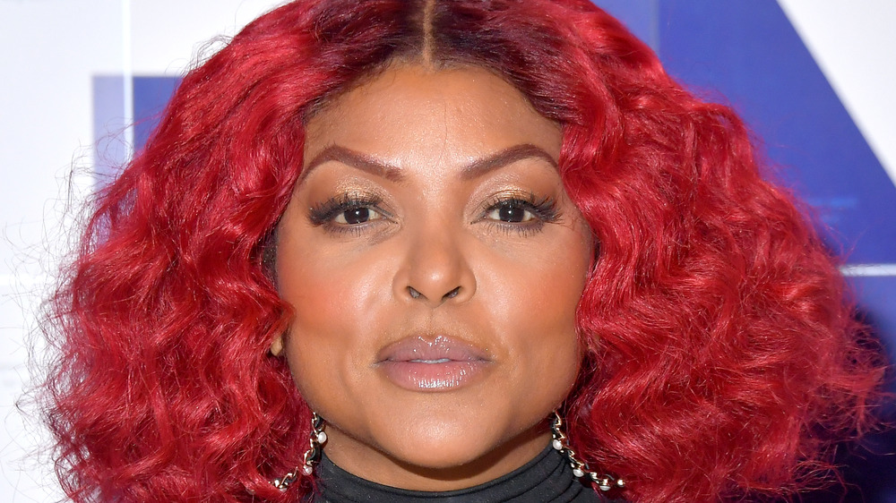 Taraji P. Henson posing with red hair at an event