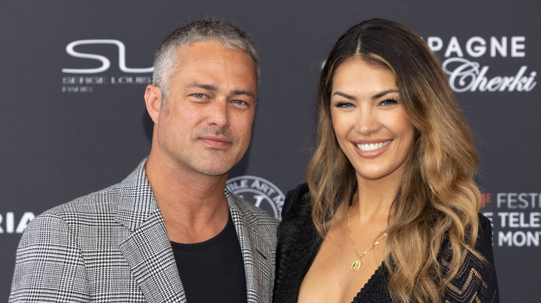 Taylor Kinney with Ashley Cruger posing