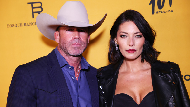 Taylor Sheridan and wife Nicole Muirbrook posing for photos.