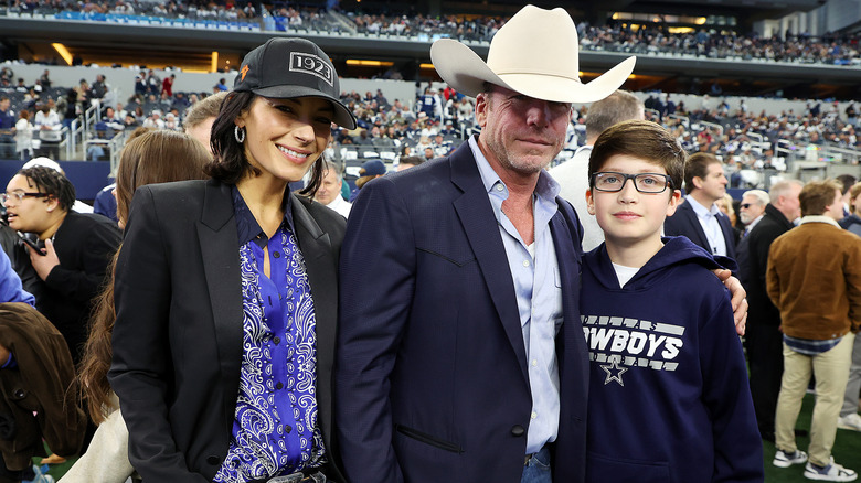 Taylor Sheridan and Nicole Muirbrook attending a Dallas Cowboys game with their son.