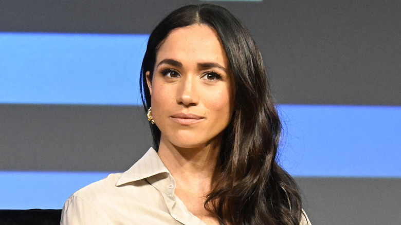 Meghan Markle listens with serious expression at the 2024 SXSW Conference and Festival