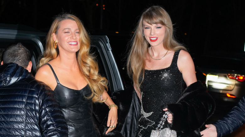 Blake Lively and Taylor Swift smiling in matching black outfits