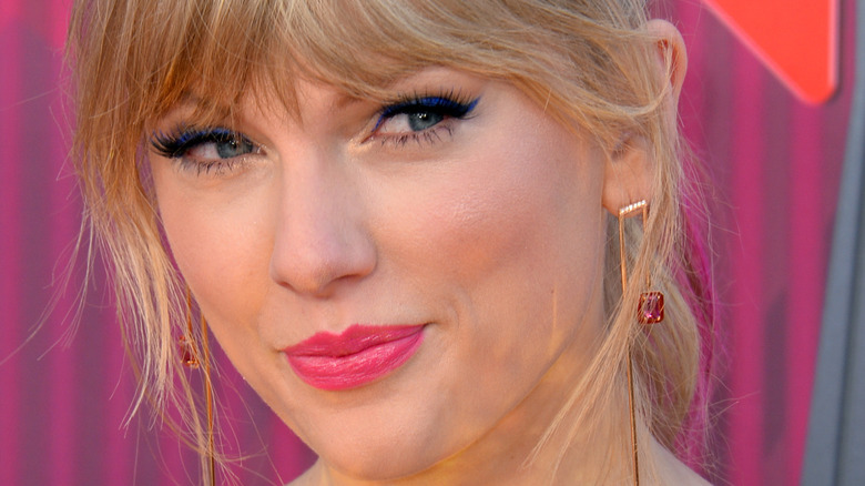 Taylor Swift smiles in a sequin dress