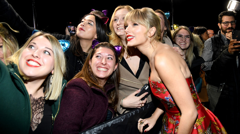 Taylor Swift poses with fans