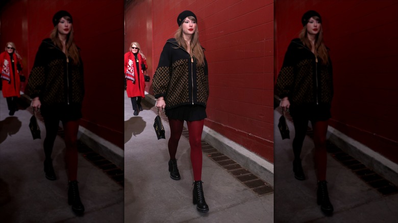 Taylor Swift wearing red leggings and a hat