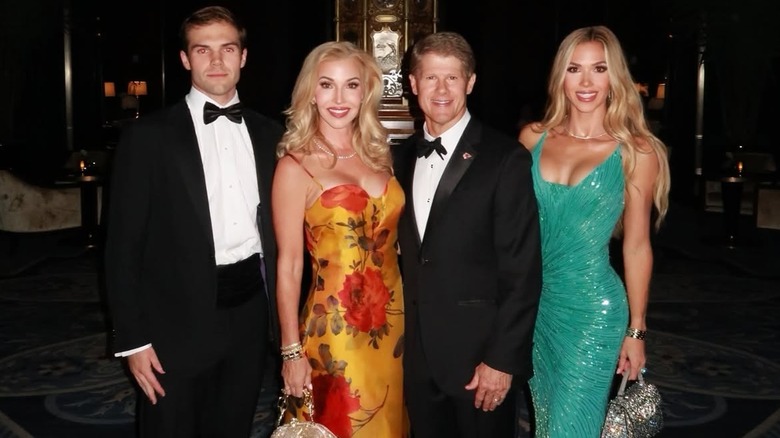 Tavia Hunt, Clark Hunt, and Gracie Hunt posing in their attire for Taylor Swift's wedding.