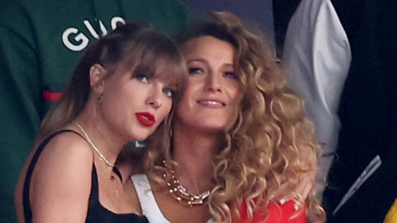 Blake Lively and Taylor Swift hug at a football game