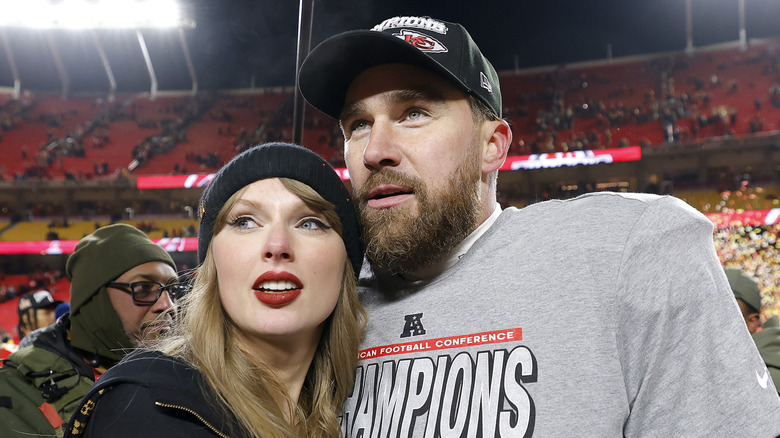 Taylor Swift and Travis Kelce embrace at a football game