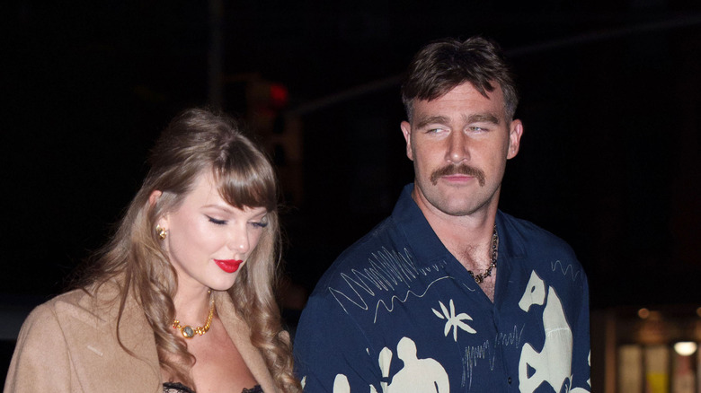Taylor Swift and Travis Kelce walk together