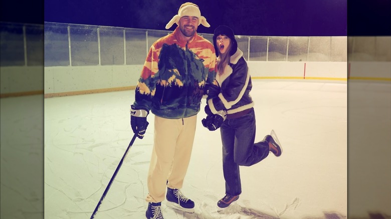 Taylor Swift and Travis Kelce holding hands while ice-skating.