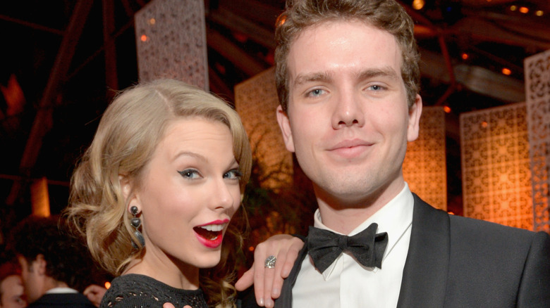 Taylor Swift and her brother Austin Swift posing for a photo