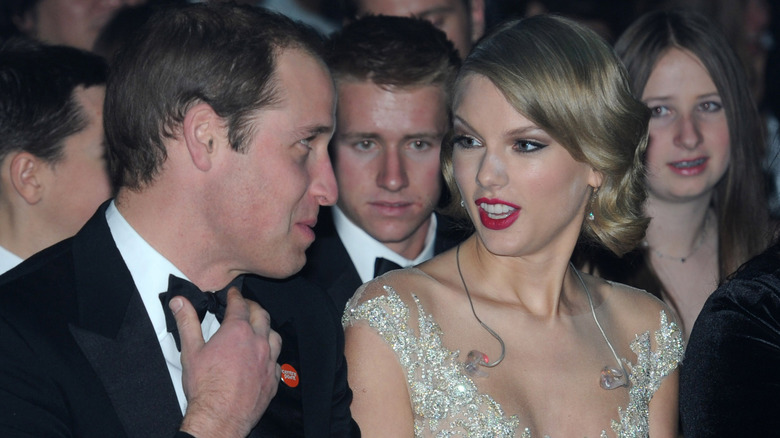 Prince William speaking to Taylor Swift in the audience at the 2013 Winter Whites Gala
