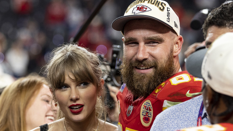 Taylor Swift and Travis Kelce celebrating after football game.